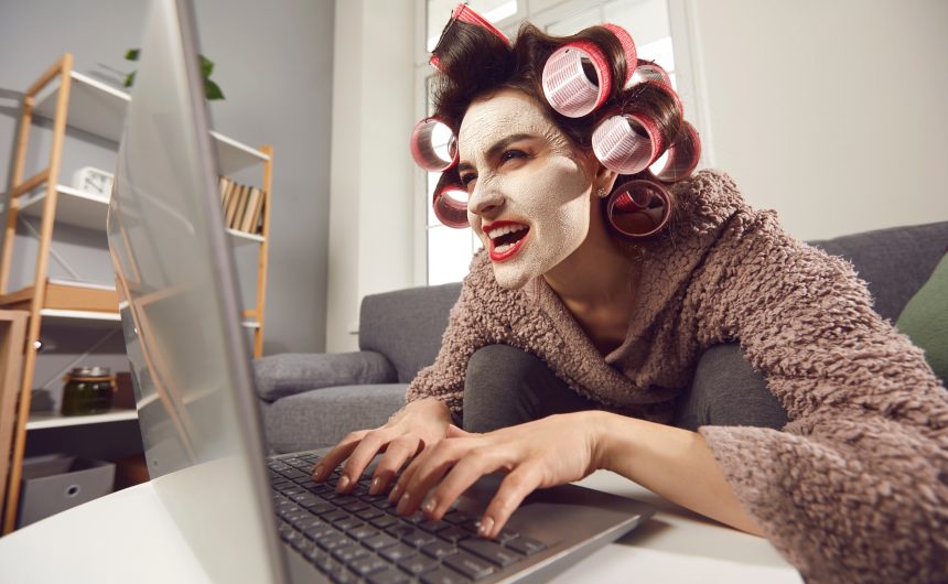 Mad Woman Sitting at Laptop and Leaving Insulting Comments on People's Social Media