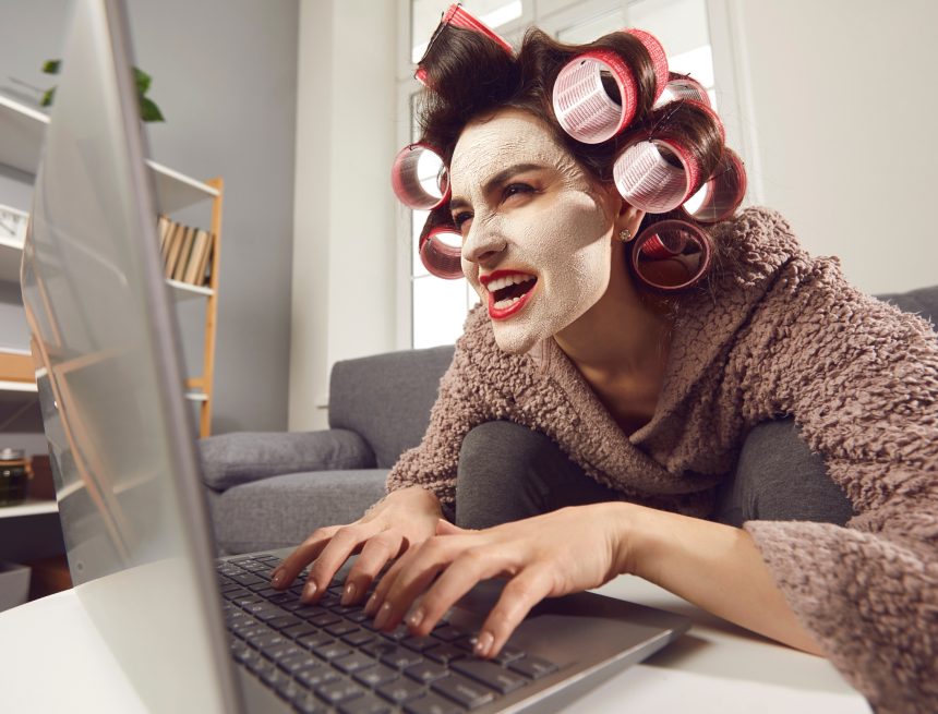 Mad Woman Sitting at Laptop and Leaving Insulting Comments on People's Social Media