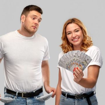 Couple with Money and Empty Pockets