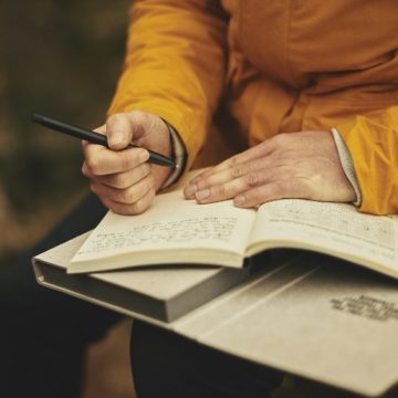 Backpacker Writing in his Journal