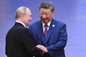 Russian President Vladimir Putin, left, and Chinese President Xi Jinping greet each other at a ceremony to welcome Heads of States of the Shanghai Cooperation Organization (SCO) summit in Tianjin, China, Sunday, Aug. 31, 2025. (Sergei Bobylev, Sputnik, Kremlin Pool Photo via AP)