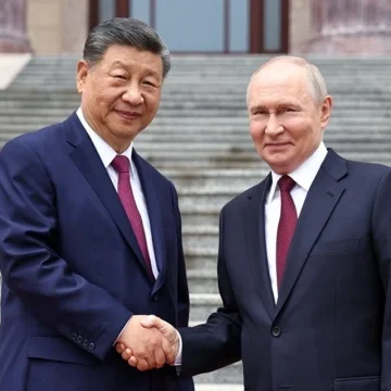 Russian President Vladimir Putin shakes hands with Chinese President Xi Jinping during a welcoming ceremony at the Great Hall of the People in Beijing, China, 20 May 2026. (Sputnik/Alexander Kazakov/Pool via Reuters)